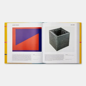 open art book showing abstract geometric painting and textured cube sculpture