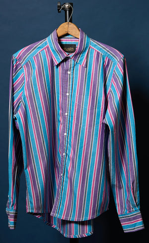 Striped shirt on a hanger against a dark background