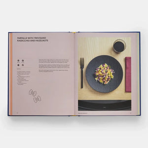 Open cookbook showing a recipe for farfalle with Trevisano, Radicchio, and Hazelnuts.