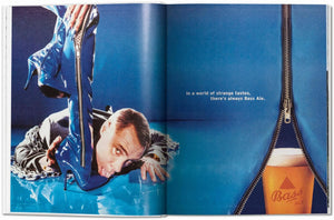 Surreal Bass Ale ad with man in chains licking blue high-heeled boot, pint behind zipper, bold blue background.