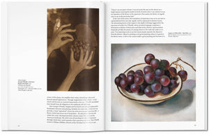 Open book showing a page with a still life painting of grapes and another with text.