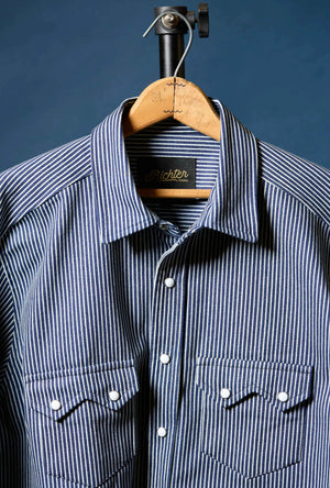 Blue and white striped shirt on a hanger against a dark blue background