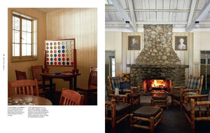 Lodge common area with rustic stone fireplace, wooden chairs, board games, and portraits