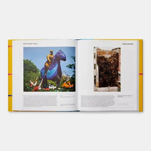 Open art book front showing colorful sculpture and chair installation photographs