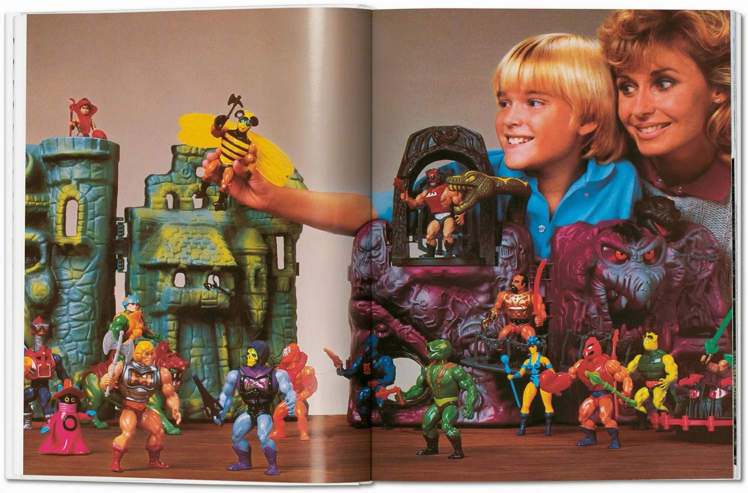 Open book showing toy figures and a photo of a boy and woman with toys.