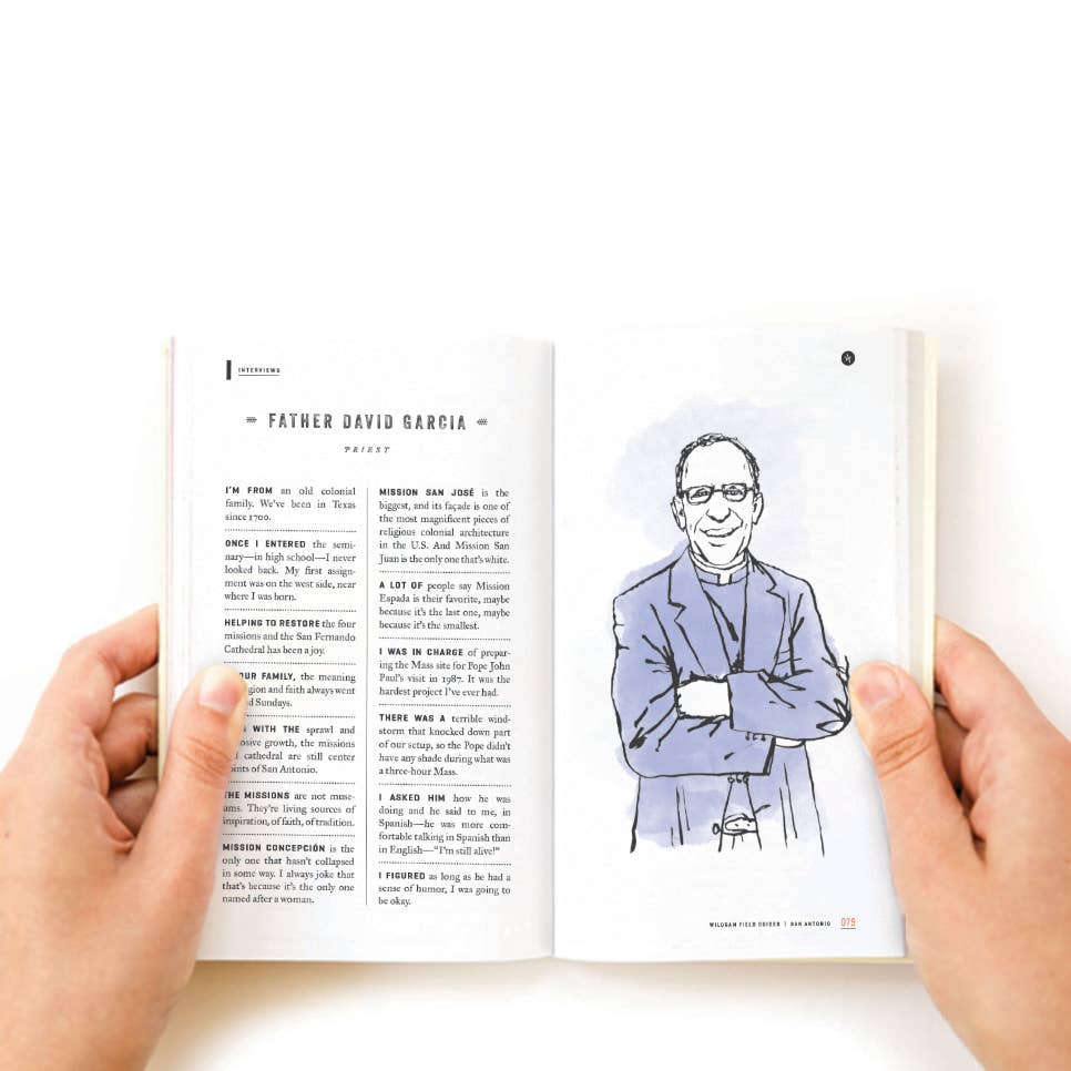 Person holding a book open to a page with text and an illustration of a person in a blue shirt.
