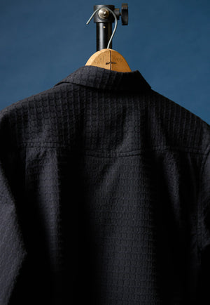 Richter179 back, textured black western shirt for men on hanger against blue background