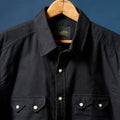 Richter186 front, black western pearl snap shirt with collar and chest pockets on hanger