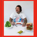 Book cover featuring a person with tattoos sitting at a table with food, on a red background with text about Matty Matheson and the book title.