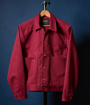 Red jacket on a hanger against a blue background